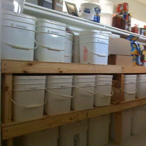 Emergency food stored in white buckets on shelves