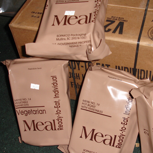 Several MRE emergency food kits spread out on boxes