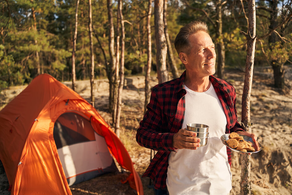 man outdoors enjoying survival dessert