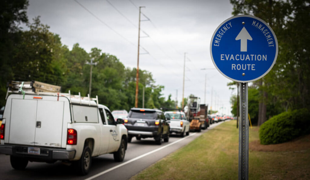 line of vehicles following evacuation route during a hurricane