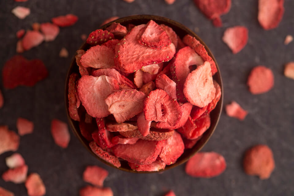 sliced freeze-dried strawberries in a bowl on a table