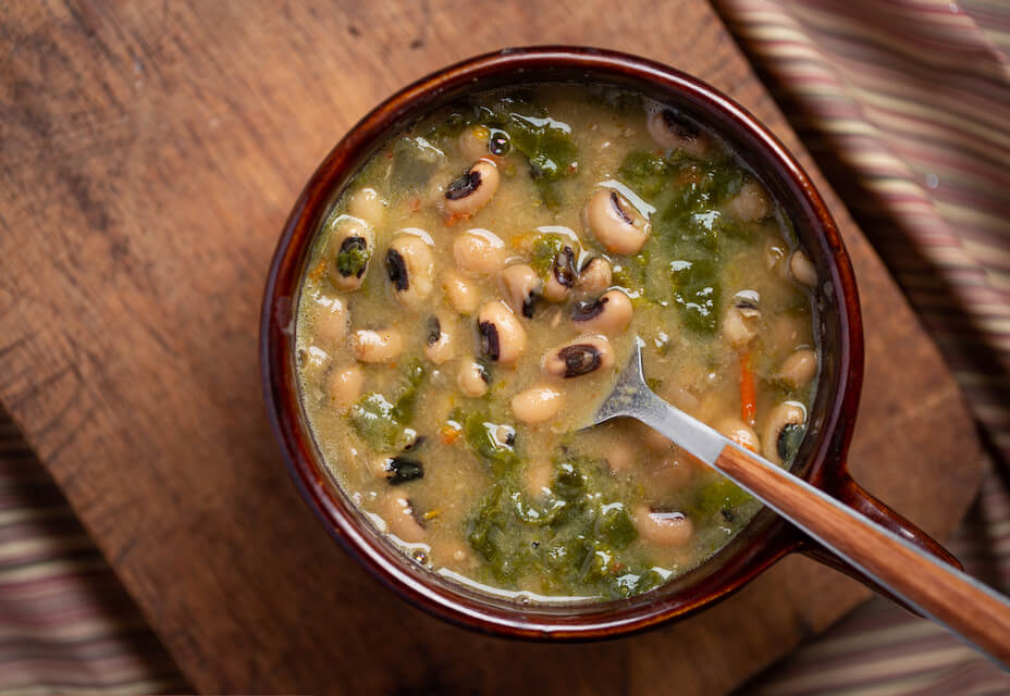 bowl of bean soup on a wooden table